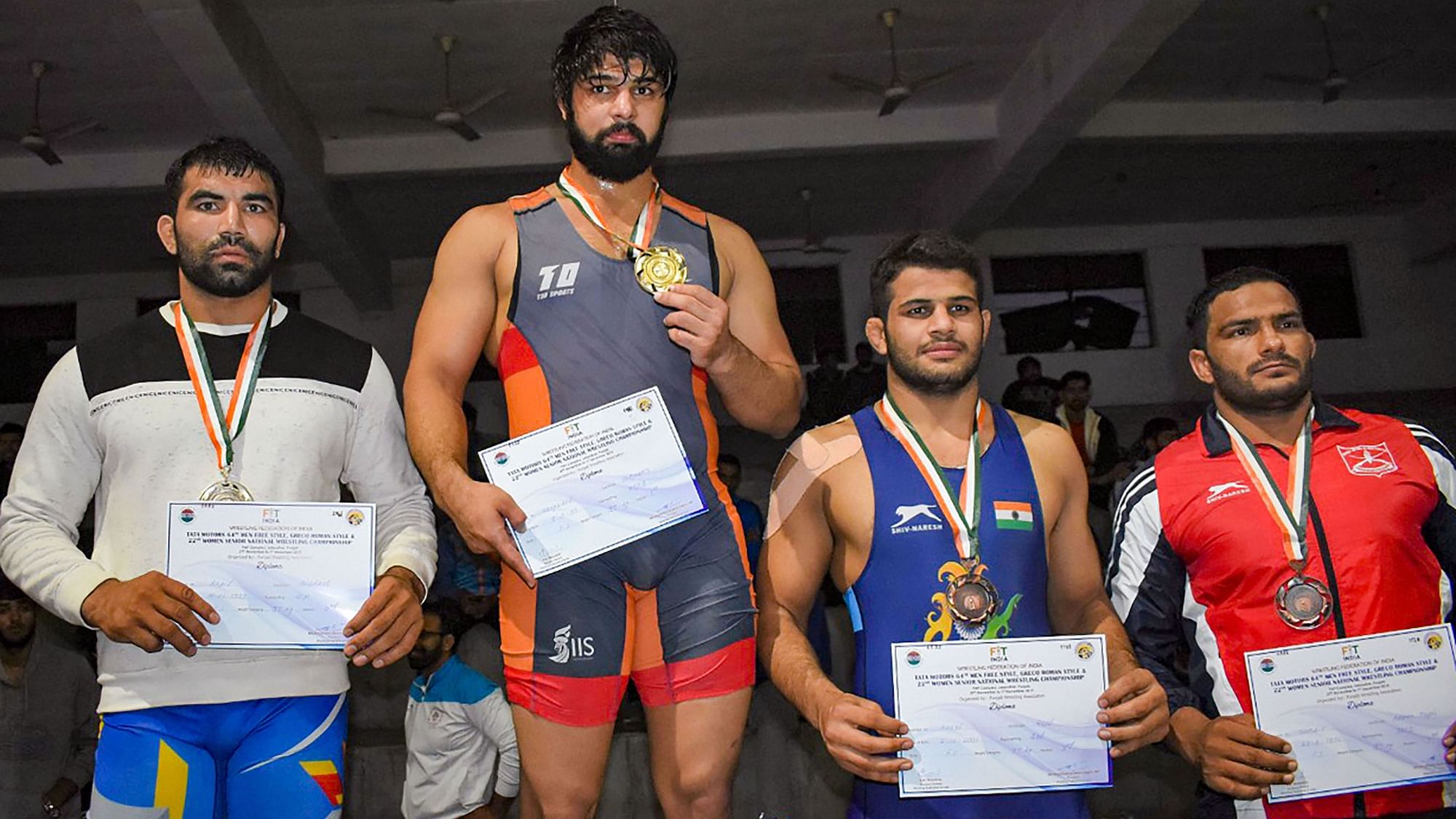 Wrestler Satyawart Kadiyan (2nd from Left) wins gold as Praveen Rana settles for silver with other medallists on the first day of Tata Motors Senior National wrestling Championship, in Jalandhar on Friday, 29 November.