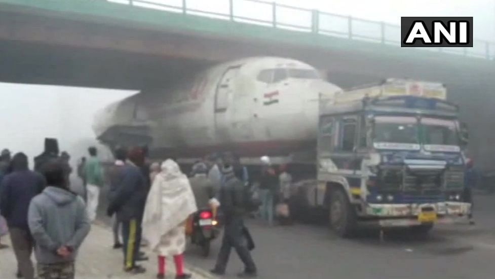 The abandoned plane stuck under the flyover.