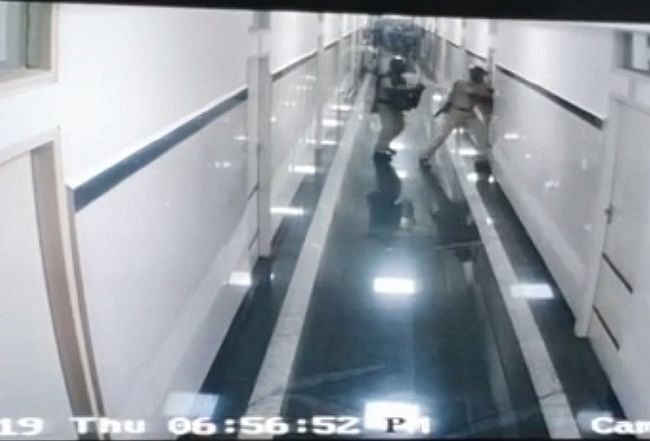 CCTV footage from a hospital show police officers chasing people into the intensive care unit through the corridors.