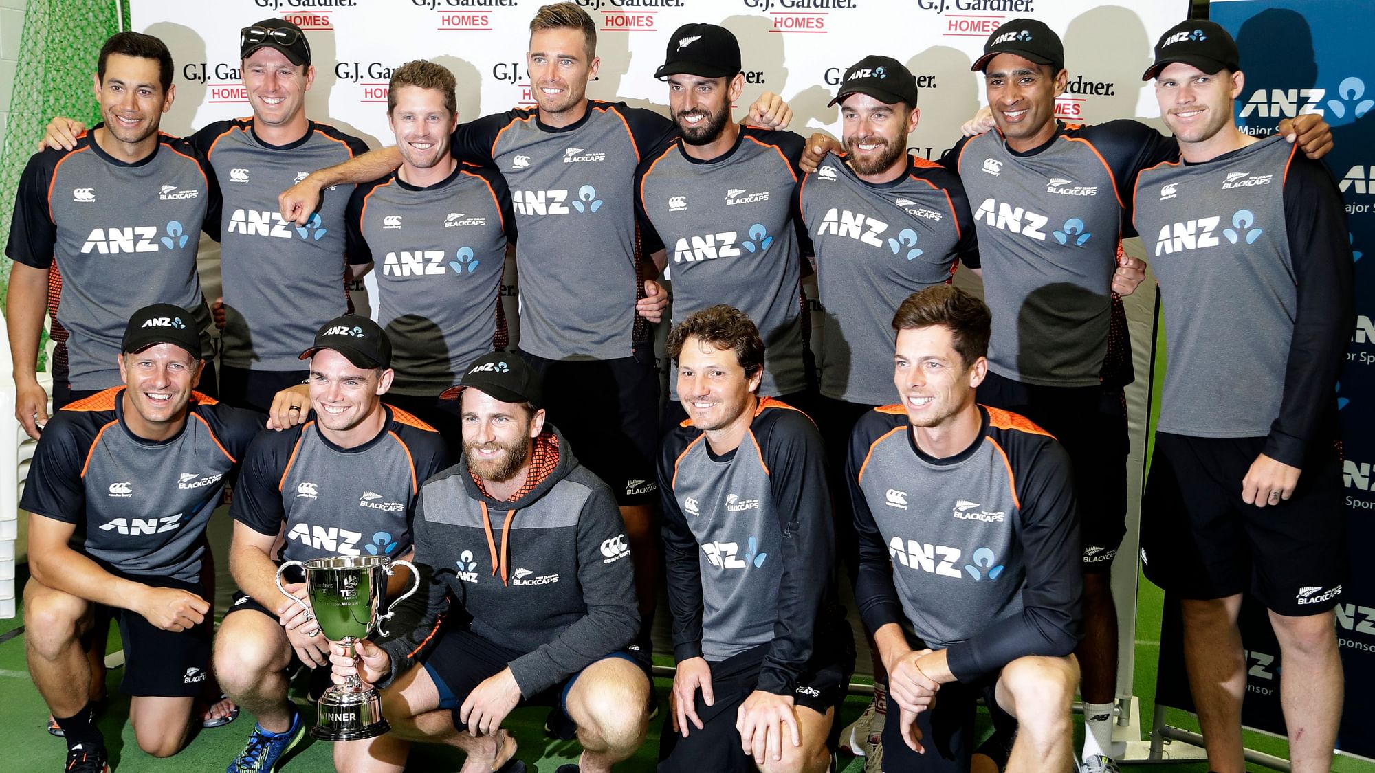 New Zealand players pose for a team photo with the trophy following play on the final day of the second cricket test between England and New Zealand at Seddon Park in Hamilton, New Zealand, Tuesday, Dec. 3, 2019. New Zealand won the series one nil after rain ended the game early.