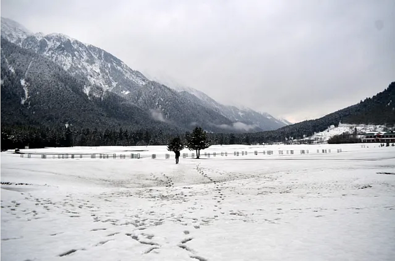 Foot-marks on a white expanse of snow in Kashmir.