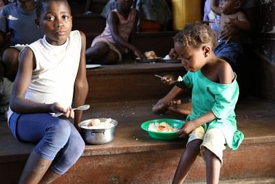 BEIRA, March 23, 2019 (Xinhua) -- Two children have lunch at a temporary accommodation center in Beira, Mozambique, on March 22, 2019. Victims were being sheltered at one of the temporary accommodation centers set in Samora Moises Machel High School in Beira, central Mozambique. Most of the victims