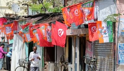 Balurghat: Flags of various political parties are on display at a roadside shop in Balurghat of West Bengal, on April 9, 2016. (Photo: IANS)
