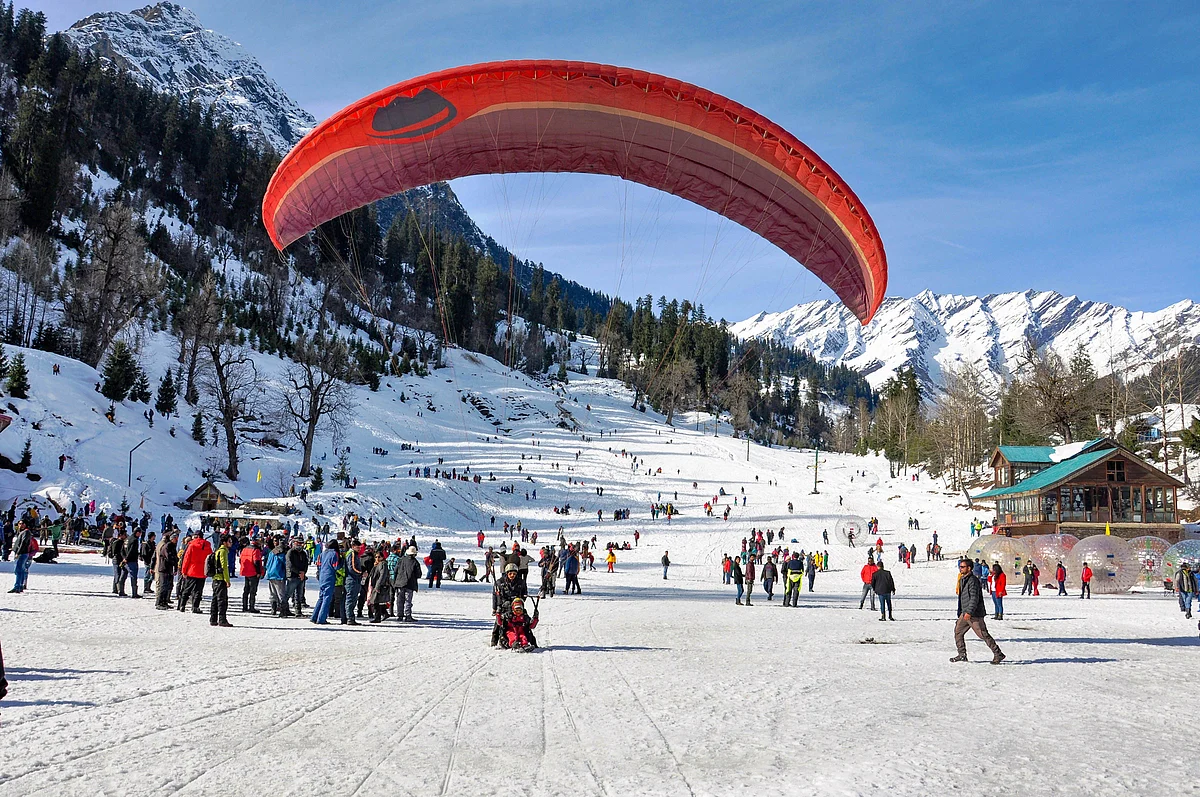 Tourists engage themselves in various activities in the snow-covered Solang valley in Manali on Monday, 23 December.