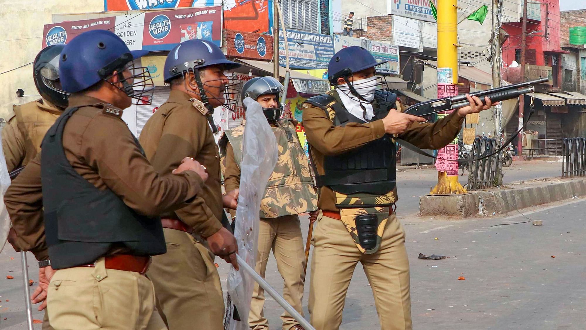  Police personnel aims a gun at protestors during a rally against NRC and amended Citizenship Act that turned violent, at Khadara area of old Lucknow. Image used for representational purposes.