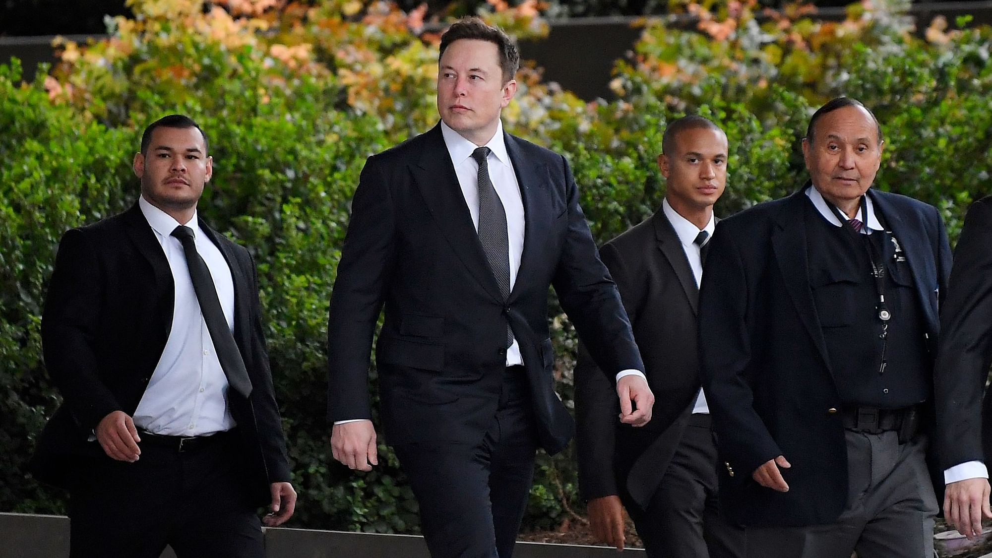 Tesla CEO Elon Musk, second from left, arrives at US District Court.