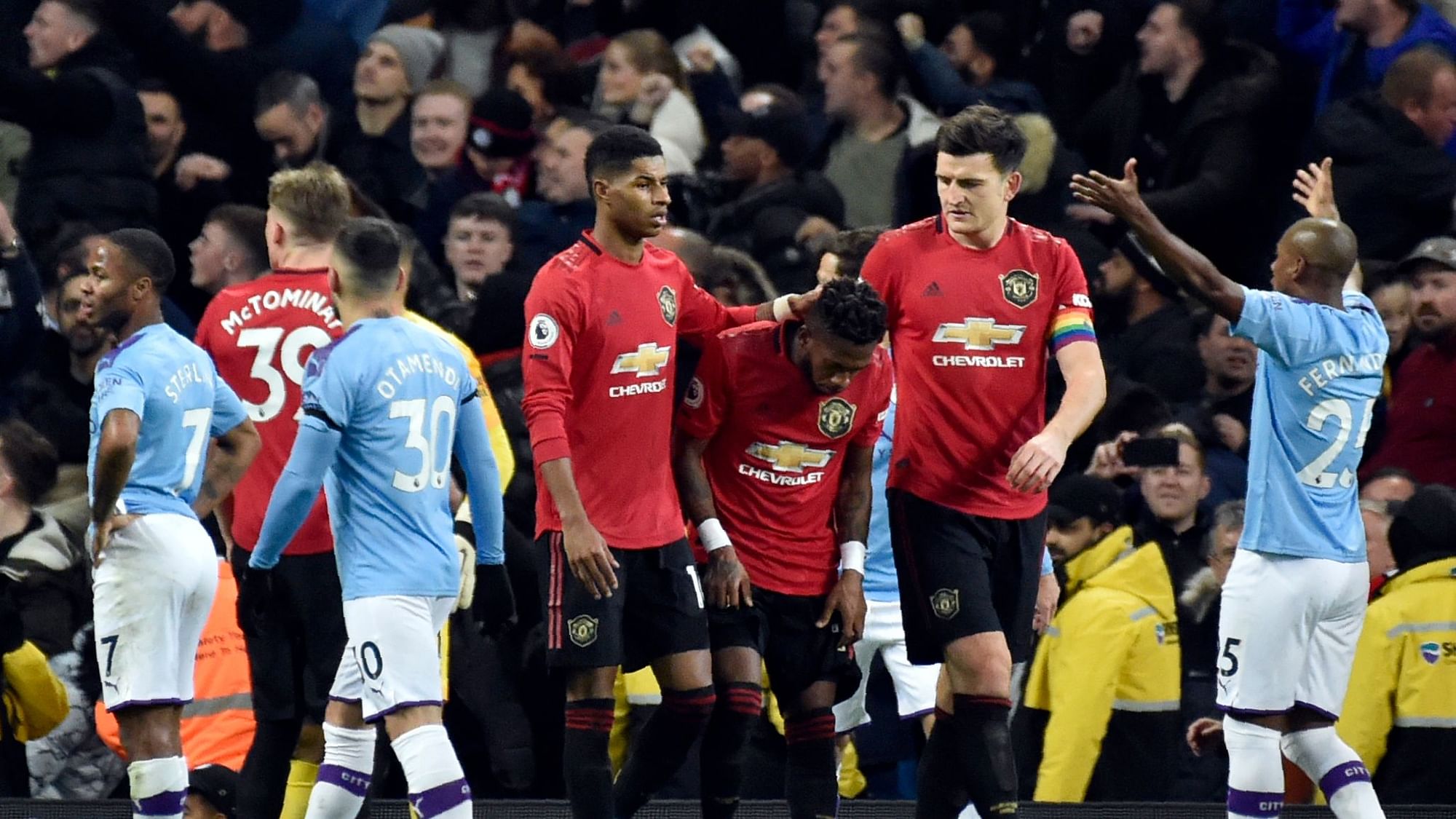 Manchester United’s Fred, center, reacts to items thrown at him by Manchester City fans during the English Premier League soccer match between Manchester City and Manchester United.