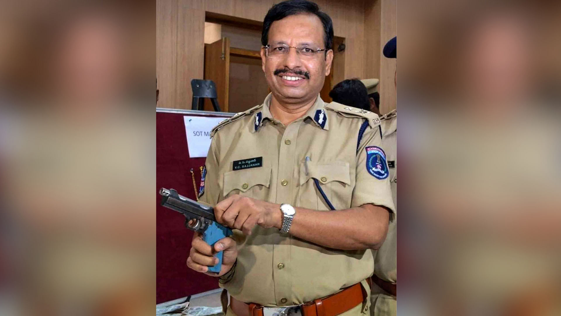 Cyberabad Police Commissioner V C Sajjanar poses with a gun.
