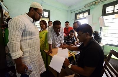 Nagaon: People get their names checked on the draft list at a National Register of Citizens (NRC) Centre in Nagaon, after an additional exclusion list comprising the names of 1,02,462 persons to the draft NRC was published in Assam, on June 26, 2019. (Photo: IANS)