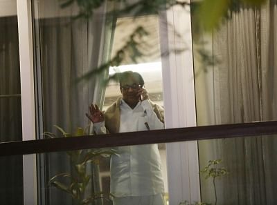 New Delhi: Former fiance Minister P. Chidambaram peeping through window at his residence after returning home from Tihar Jain on bail, in new Delhi on Dec 4, 2019. (Photo: IANS)