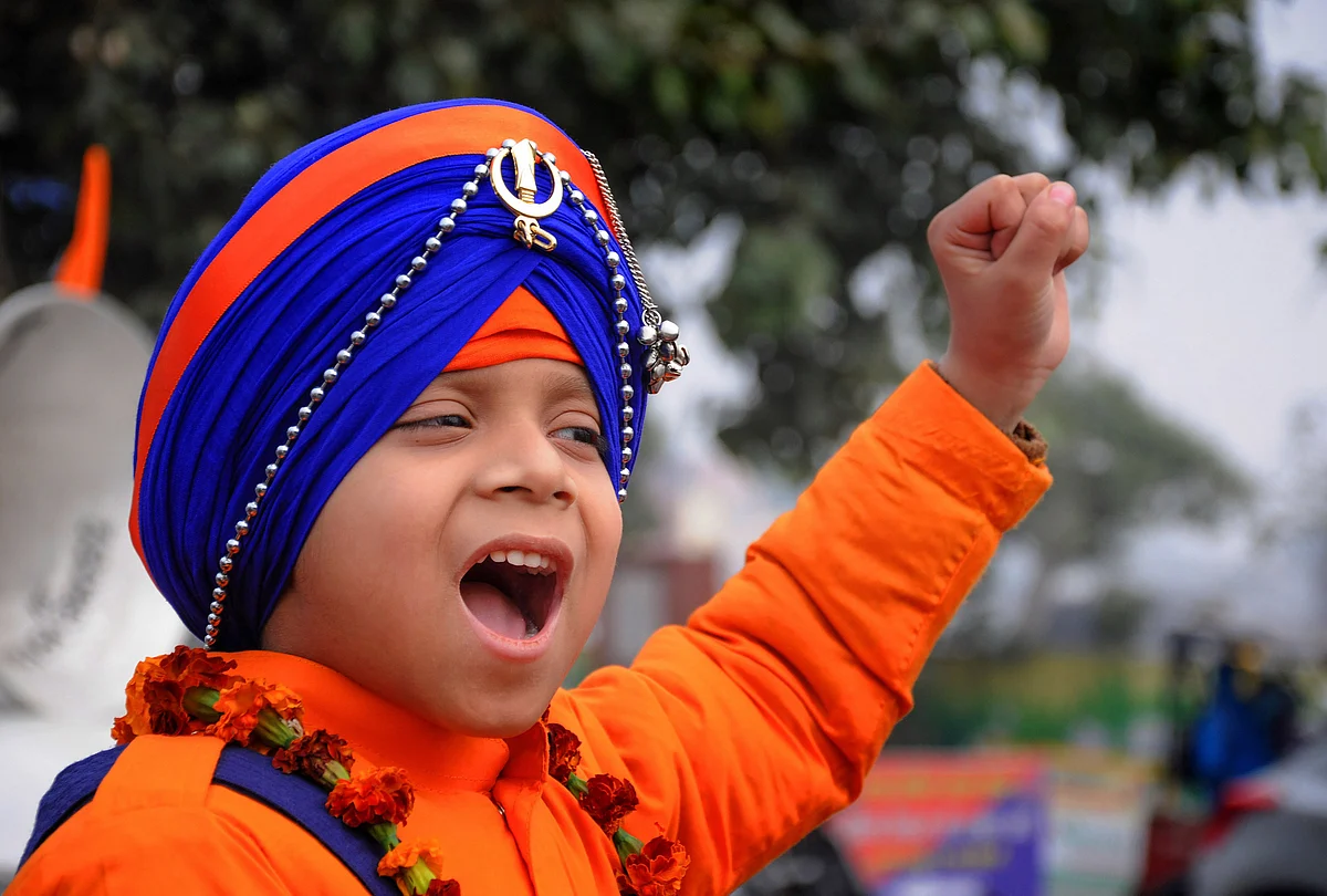 A young Sikh devotee during Nagar Kirtan procession dedicated to the martyrdom day of four Sahibzadas (sons) of the 10th Sikh Guru Govind Singh in Amritsar on Monday 23 December.