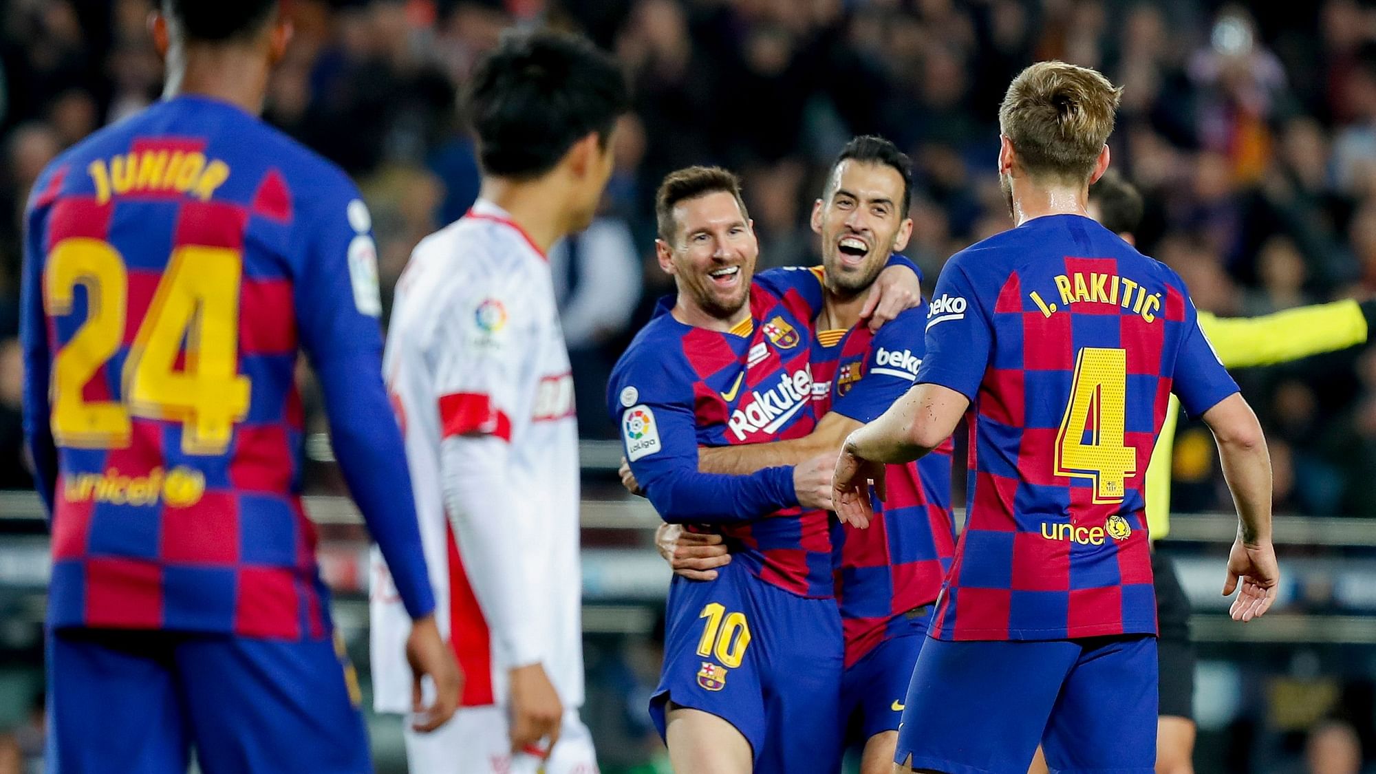 Barcelona’s Lionel Messi, center left, celebrates with Sergio Busquets after scoring his side’s second goal during a Spanish La Liga soccer match between Barcelona and Mallorca at Camp Nou stadium in Barcelona.