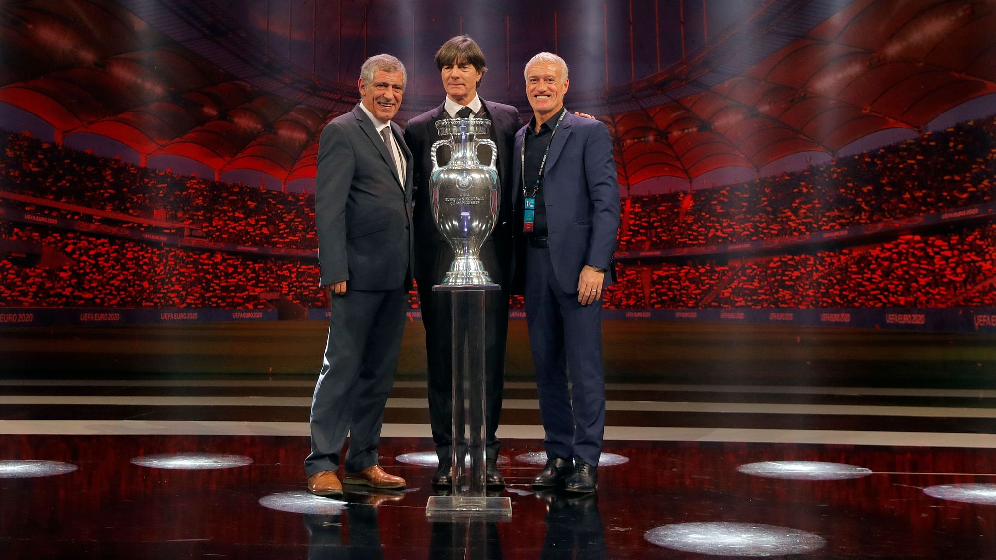 The coaches of Portugal Fernando Santos, left, Germany Joachim Loew and France Didier Deschamps who will play in group F, pose with the trophy after the draw for the UEFA Euro 2020 soccer tournament finals in Bucharest on Saturday, 30 November.