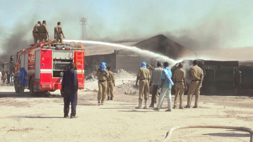 Firefighters try to put out a fire at the ceramic factory in Khartoum, Sudan.