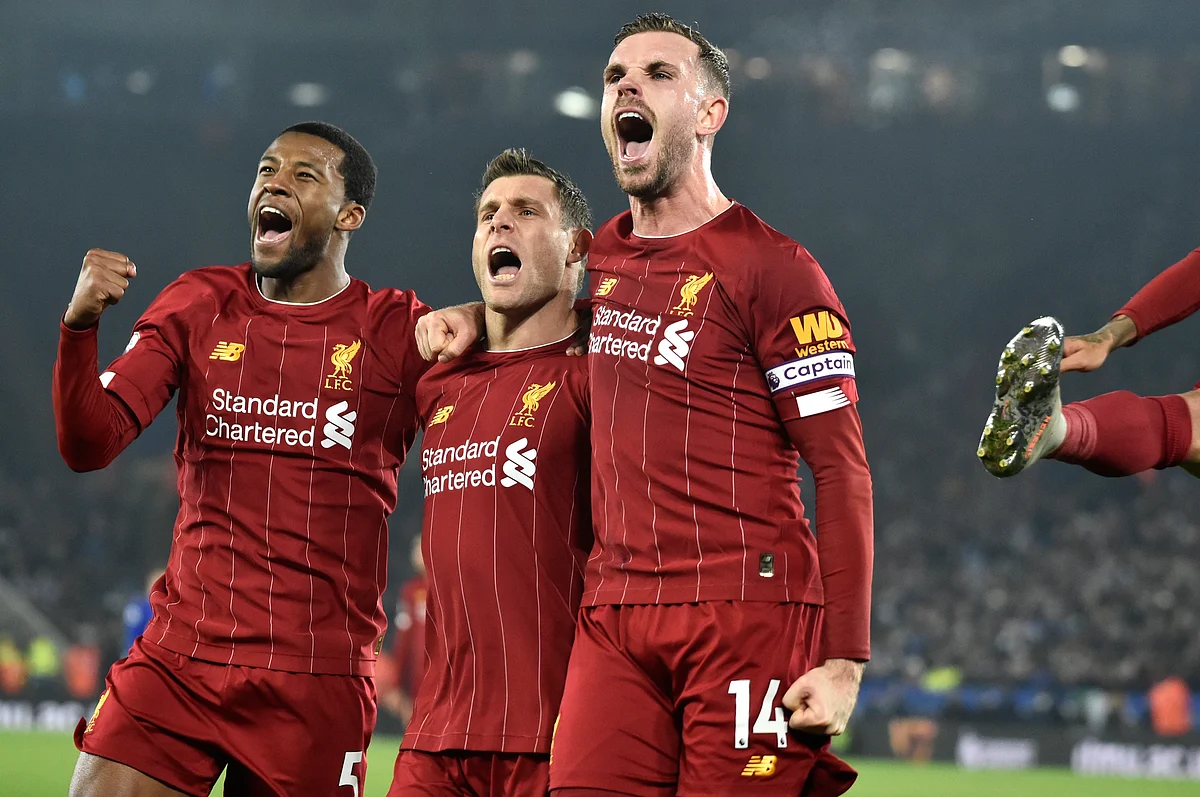 Liverpool’s James Milner, second left, celebrates with his teammate Liverpool’s Georginio Wijnaldum, left, and Liverpool’s Jordan Henderson after scoring his side’s second goal during the English Premier League match against Leicester City.