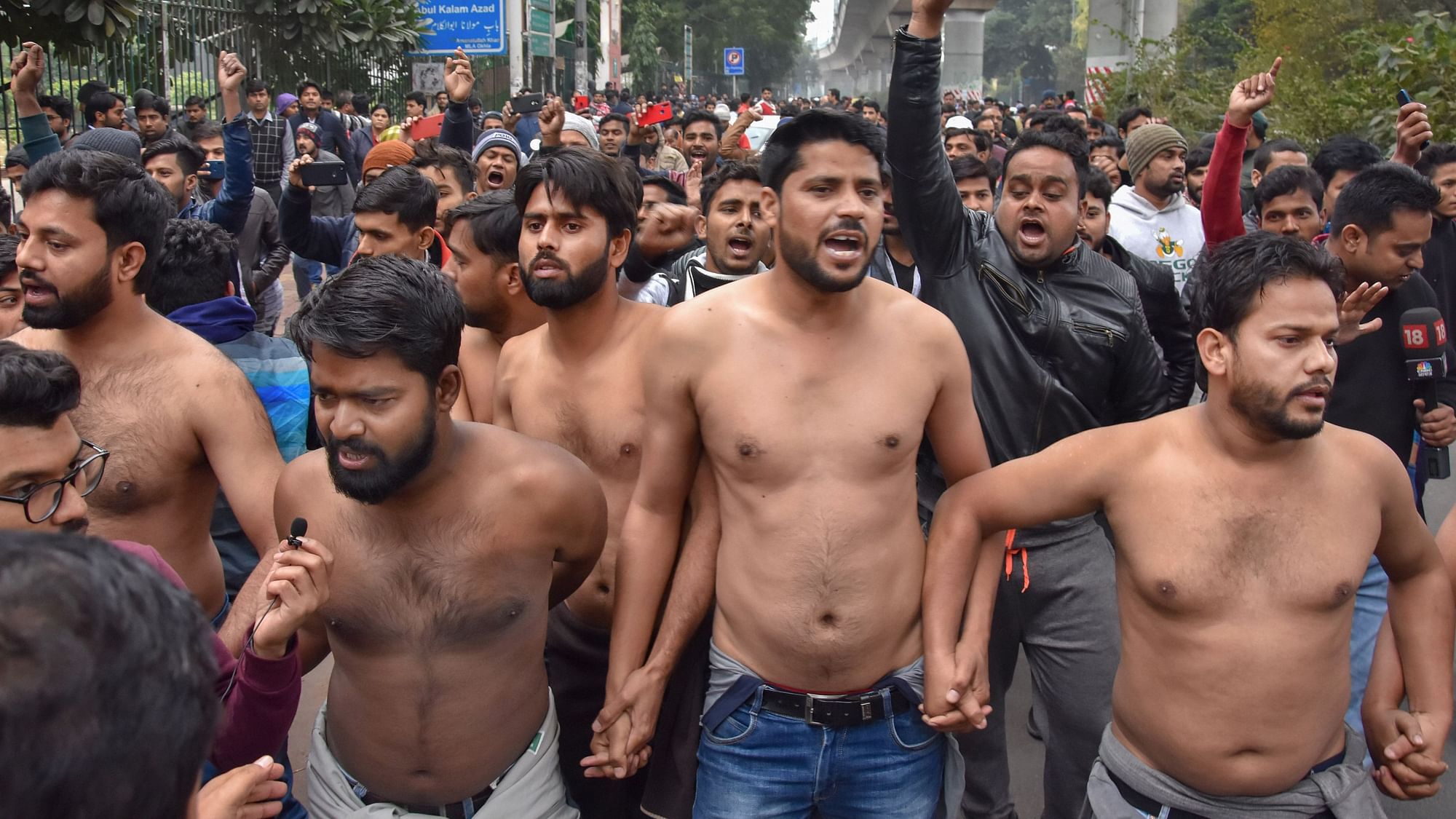 Students protest shirtless at the campus of Jamia Millia Islamia University on Monday.