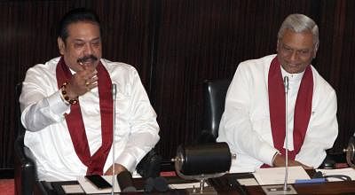 COLOMBO, Dec. 18, 2018 (Xinhua) -- Sri Lankan former President Mahinda Rajapaksa (L) attends a parliament session in Colombo, Sri Lanka, on Dec. 18, 2018. Sri Lankan former President Mahinda Rajapaksa who resigned from the prime ministerial position last Saturday was appointed as leader of the opposition at the parliament by Speaker Karu Jayasuriya on Tuesday amid objections from the ruling party. The parliament convened on Tuesday for the first time since the reinstatement of Prime Minister Ran