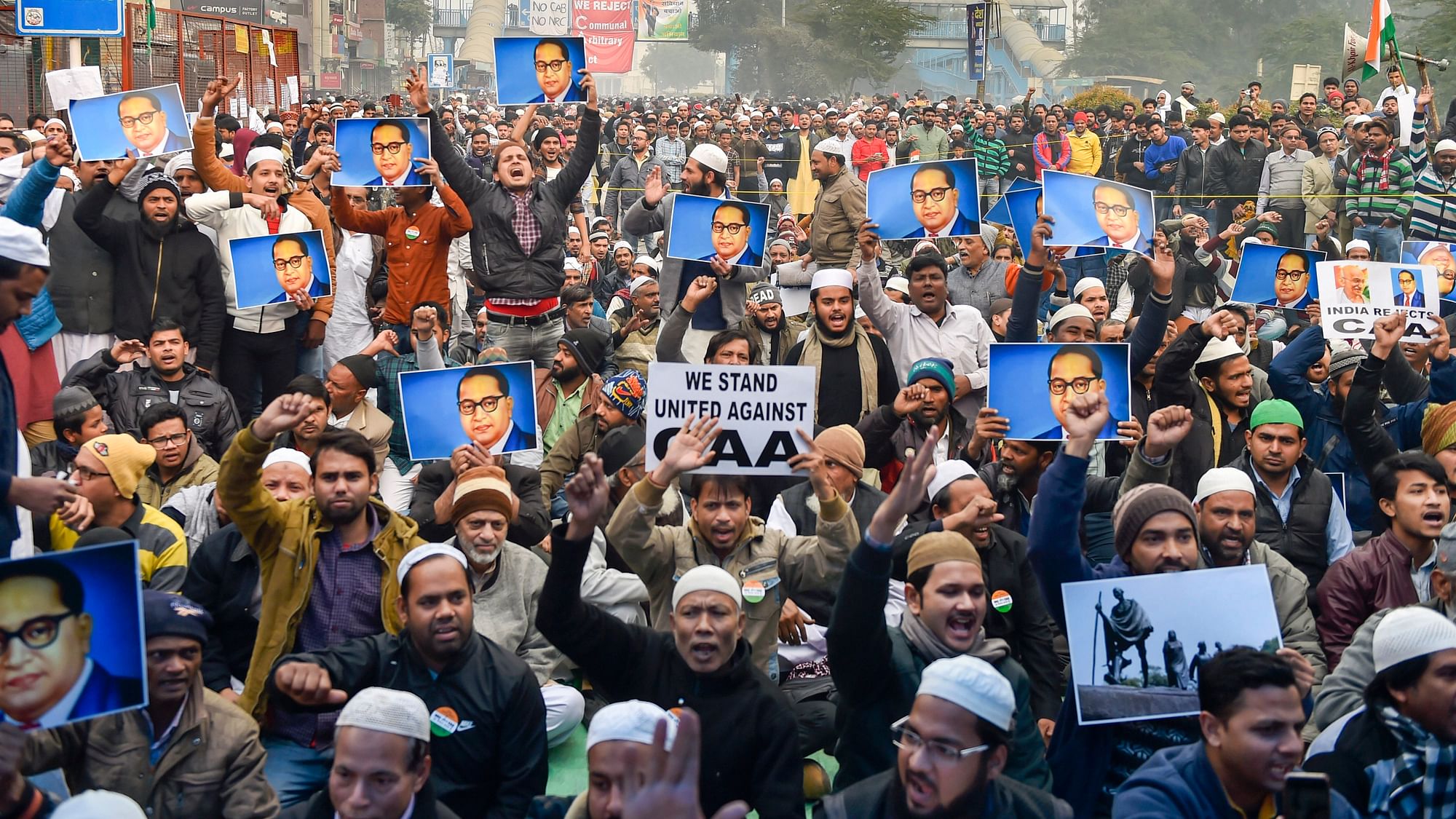 Protestors hold placards during a demonstration against the Citizenship Amendment Act (CAA) at Jamia Nagar in New Delhi, on Friday, 20 December.