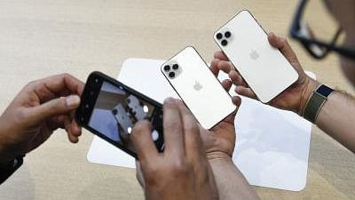 People try out the Apple iPhone 11 Pro and Pro Max during a product launch event at Apple.&nbsp;