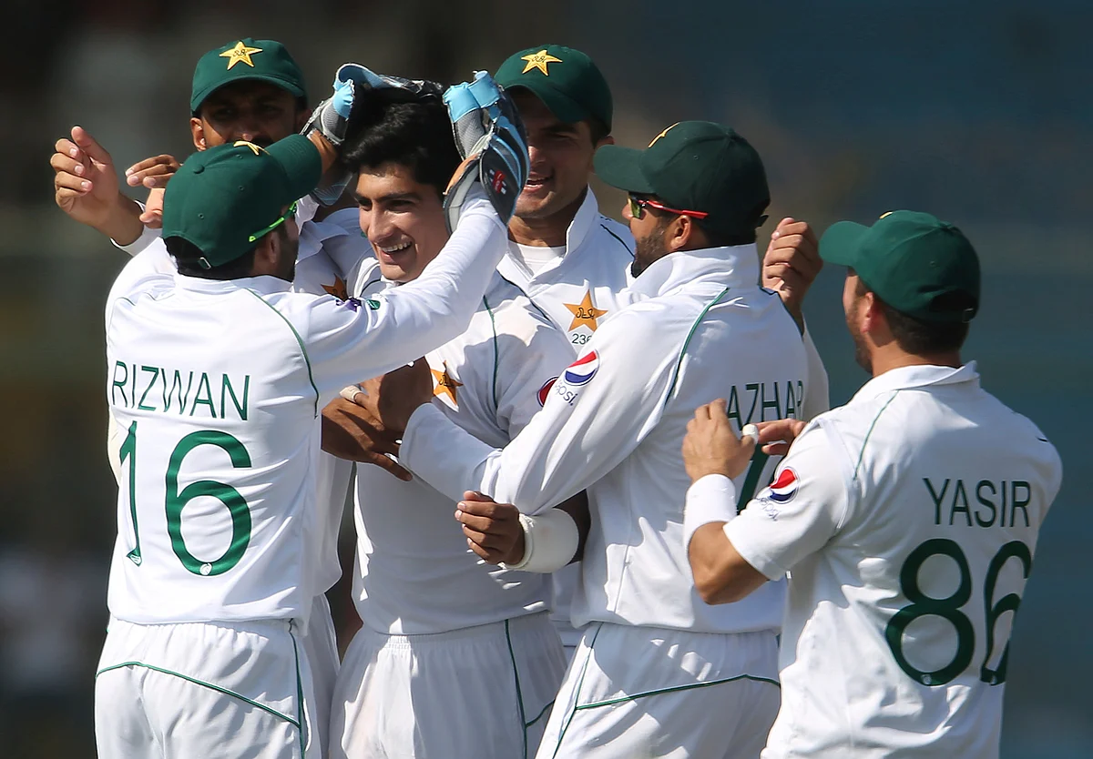 Pakistani players greet Naseem Shah after the dismissal of Sri Lankan batsman during the second Test in Karachi, Pakistan, Sunday, Dec. 22, 2019. 