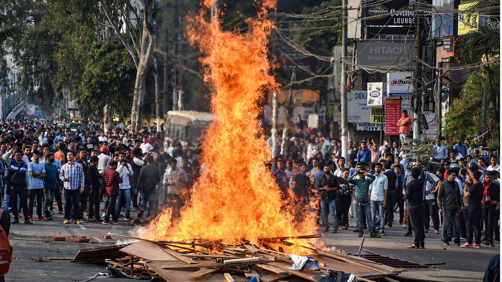 Protesters burn hoardings and other materials during their march against Citizenship (Amendment) Bill in Guwahati on 11 December.&nbsp;