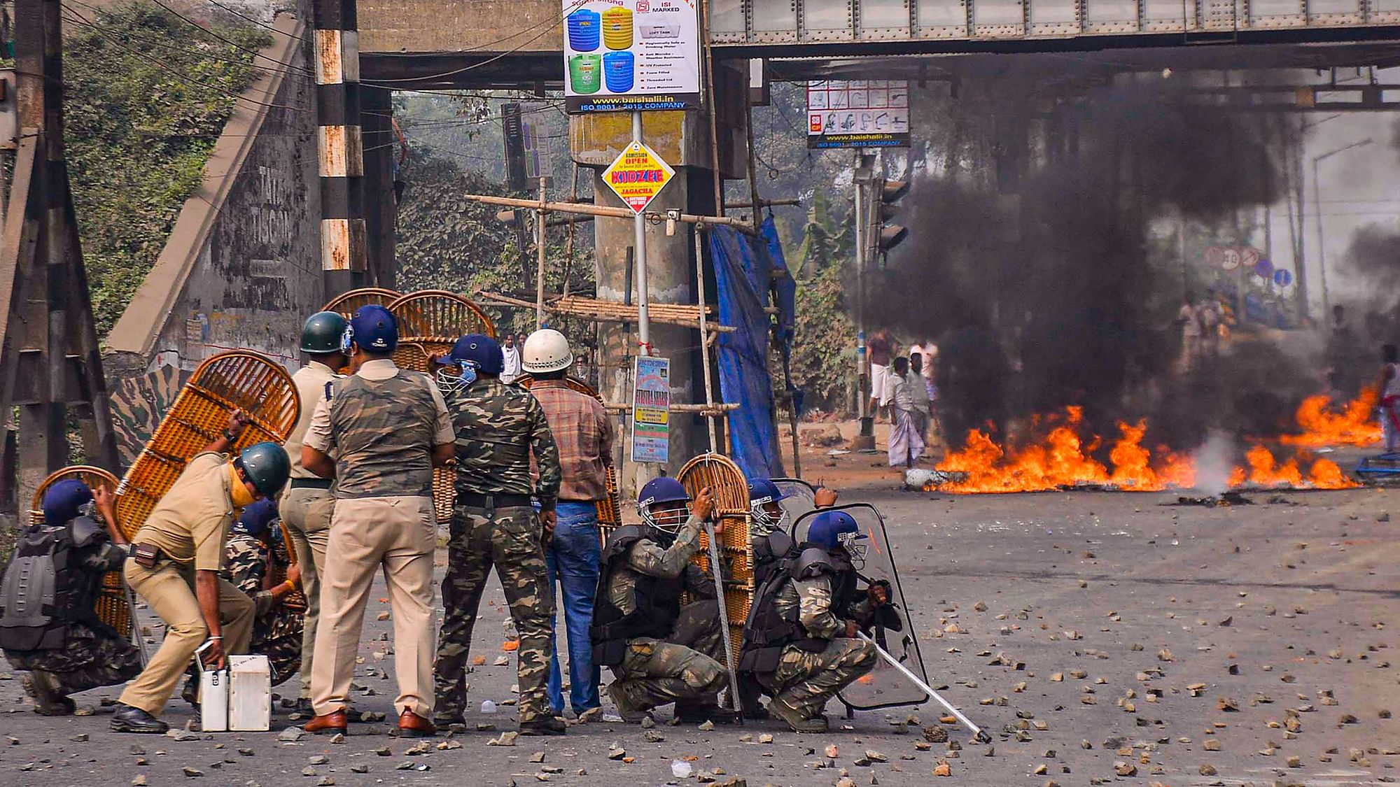 Police personnel attempt to disperse protestors during a demonstration against the passing of Citizenship Amendment Bill (CAB) at Santragachi in Howrah district of West Bengal.