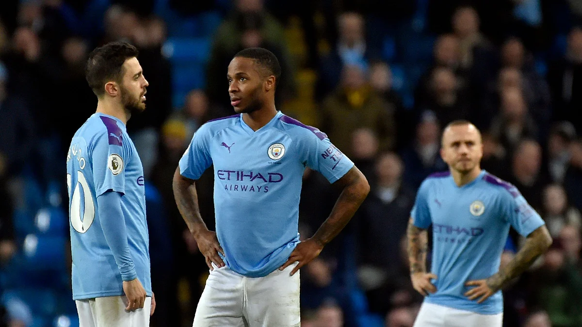 Manchester City’s Bernardo Silva, left, speaks with Manchester City’s Raheem Sterling, center, during the English Premier League soccer match between Manchester City and Manchester United.