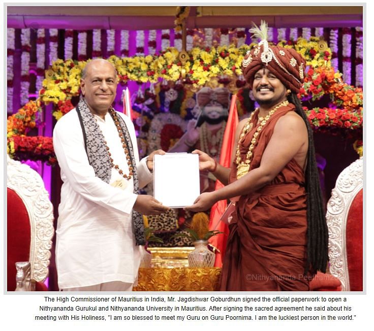 The face of the man bending in the photo to touch Nithyananda’s feet is largely concealed by the latter’s hands. 
