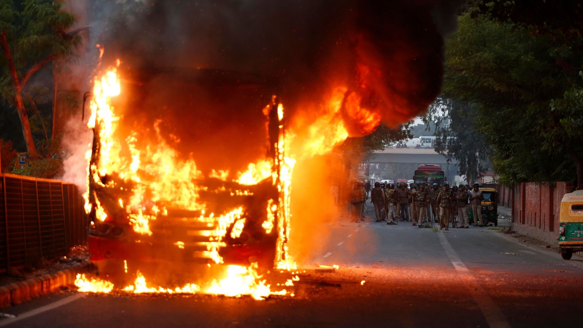 A passenger bus goes up in flames during a protest against Citizenship (Amendment) Act in New Delhi.