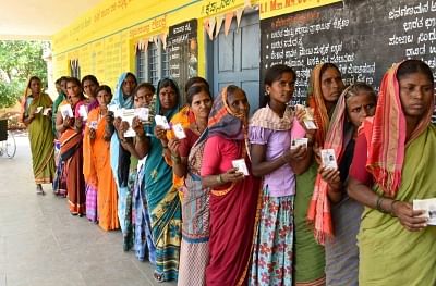 Raichur: Women voters wait in a queue to cast their votes for the third phase of 2019 Lok Sabha elections, at a polling station in Karnataka