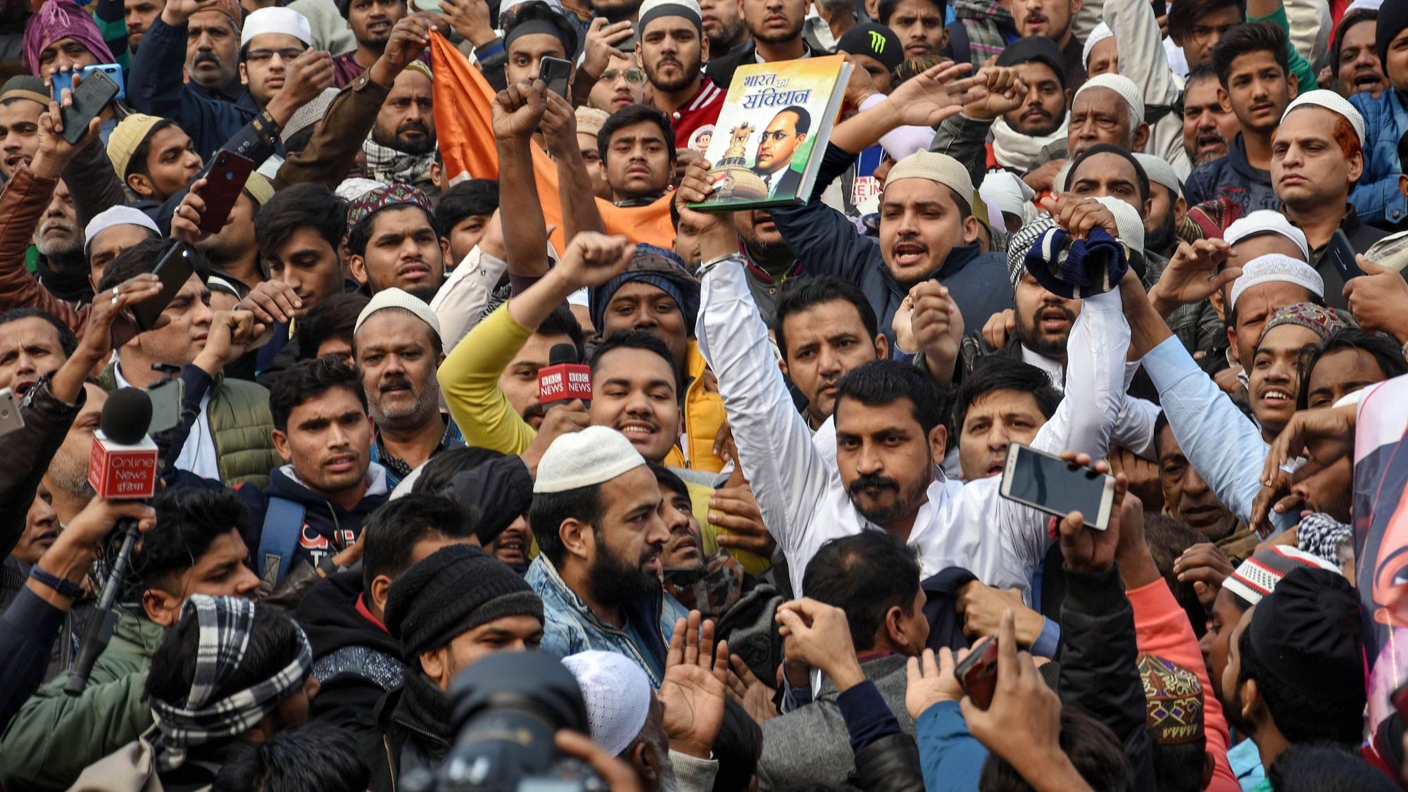 Bhim Army chief Chandrashekhar Azad holds up a copy of the Constitution of India at the Jama Masjid protest against the Citizenship Amendment Act on 20 December 2019.