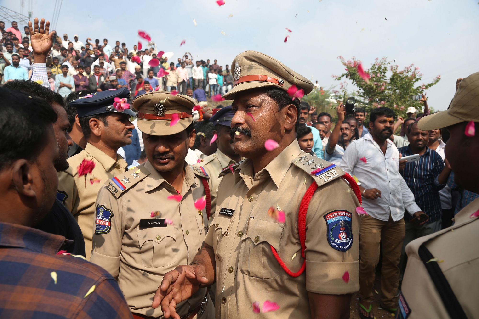 People shower flower petals on the Indian policemen guarding the area where the accused in the Hyderabad vet’s rape and murder case were shot, in Shadnagar, some 50 kilometres or 31 miles from Hyderabad.&nbsp;
