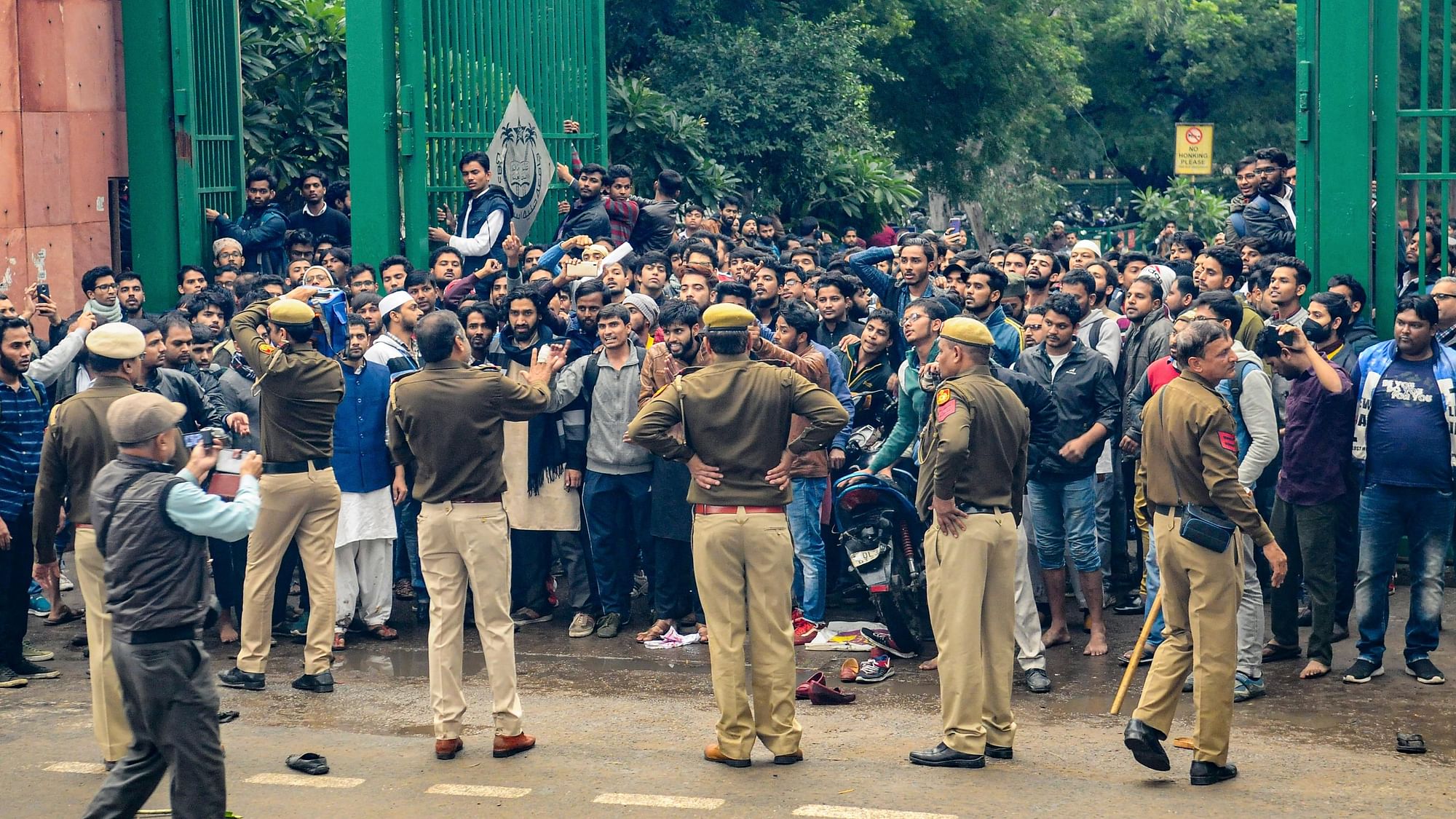 Students of Jamia Millia Islamia University clash with the police during a protest against Citizenship Act