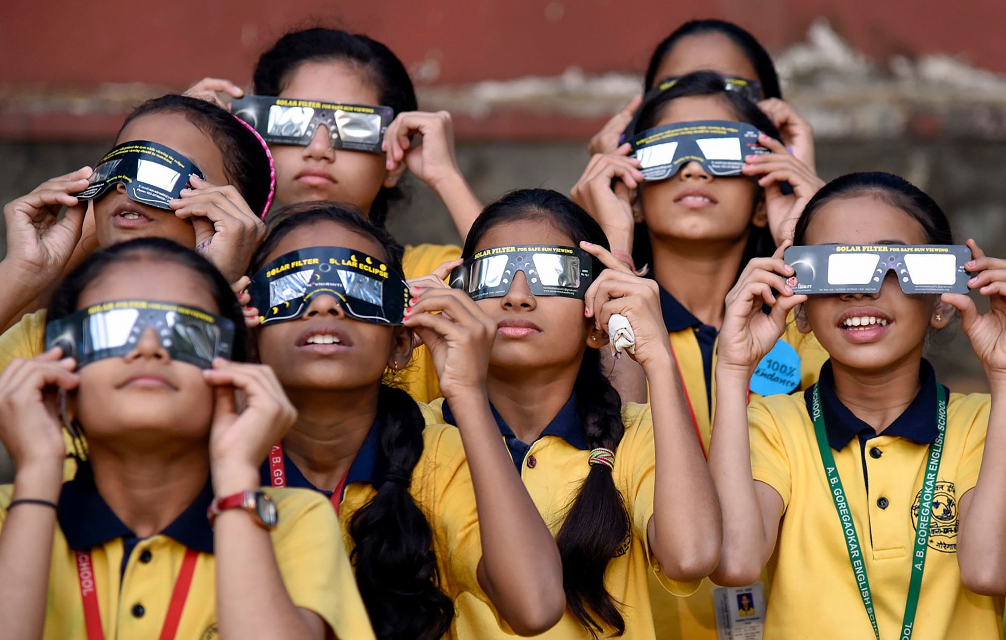 2020 Surya Garhan Today LIVE Streaming Online: School children view the the partial solar eclipse through eclipse glasses.