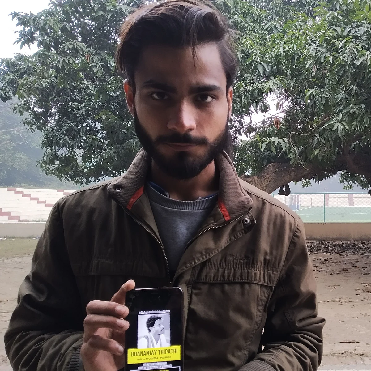 Priyesh Pander, member of BHU’s JAC (Joint Action Committee) shows photo of an activist arrested in Varanasi in connection with the CAA protests.