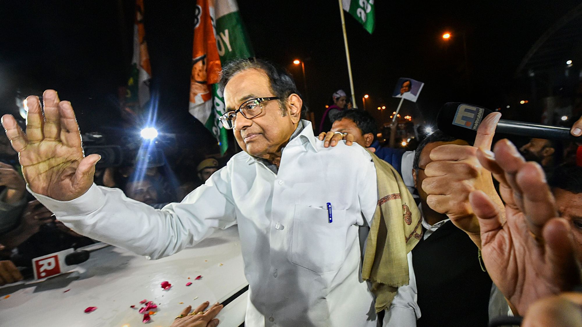 Senior Congress leader P Chidambaram waves at Congress workers and supporters after he was released from Tihar jail in New Delhi, Wednesday night, Dec. 4, 2019.