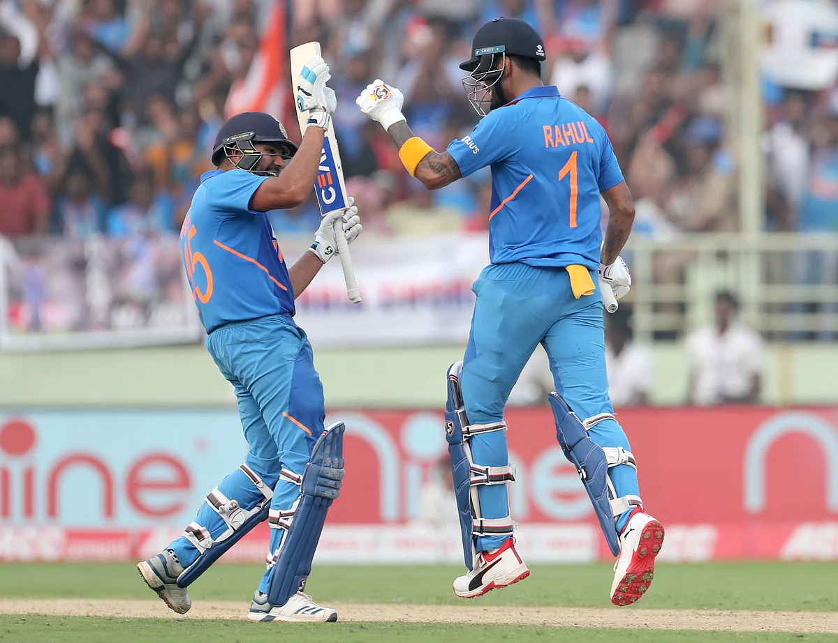 India’s KL Rahul, right, celebrates with batting partner Rohit Sharma after scoring a century during the second one day international cricket match between India and West Indies in Visakhapatnam.