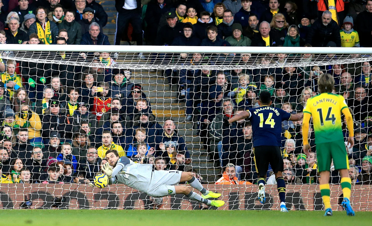 Norwich City goalkeeper Tim Krul, left, saves a penalty shot from Arsenal’s Pierre-Emerick Aubameyang, second right, during their English Premier League match at Carrow Road in Norwich, England.
