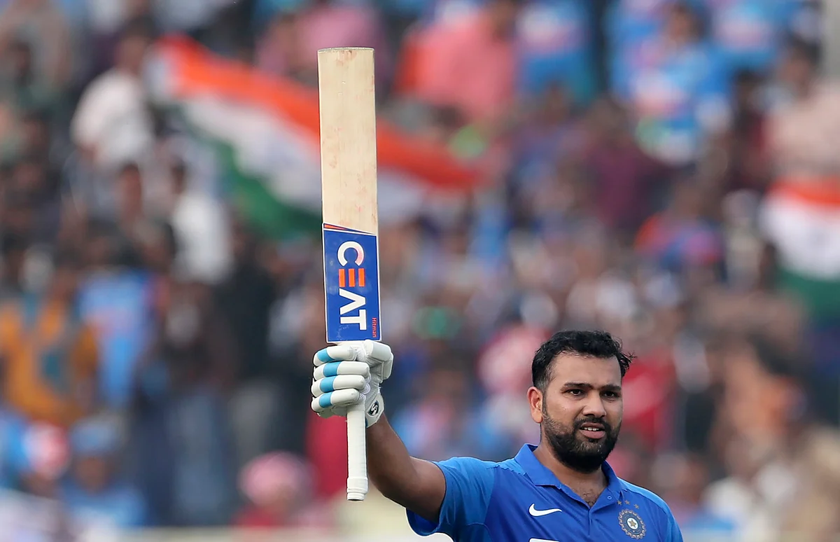 India’s Rohit Sharma raises his bat to celebrate scoring a century during the second one day international cricket match between India and West Indies in Visakhapatnam, India, Wednesday, Dec. 18, 2019. 