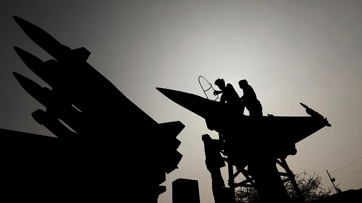 Workers give final touches to a model of Rafale fighter jet at the Indian Air Force tableaux during a press preview for the Republic Day parade, in New Delhi on 22 January. Image used for representational purposes. 