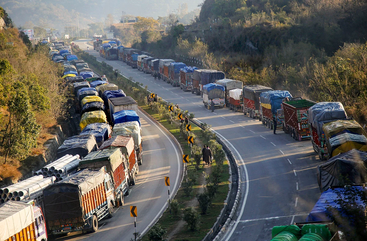 Stranded trucks wait for re-opening of Jammu and Kashmir National Highway, on the outskirts of Jammu, on Thursday, 9 January.