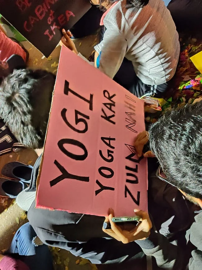 Protesters holding placards criticising the Uttar Pradesh government over the death of protestors.
