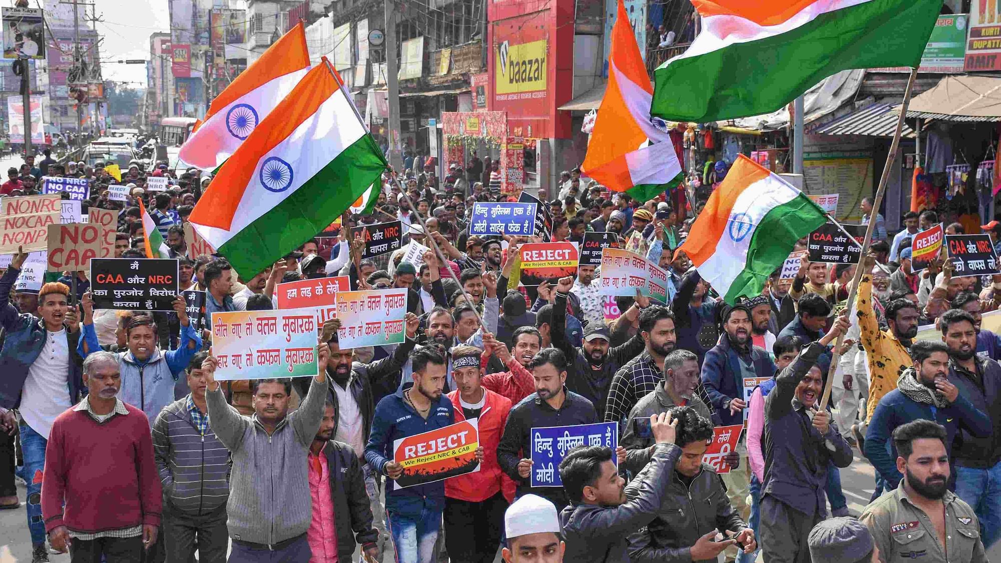 Protesters carrying the Triclour display placards and raise slogans during a rally against CAA, NRC and NPR, in Ranchi, Wednesday, 8 Jan.