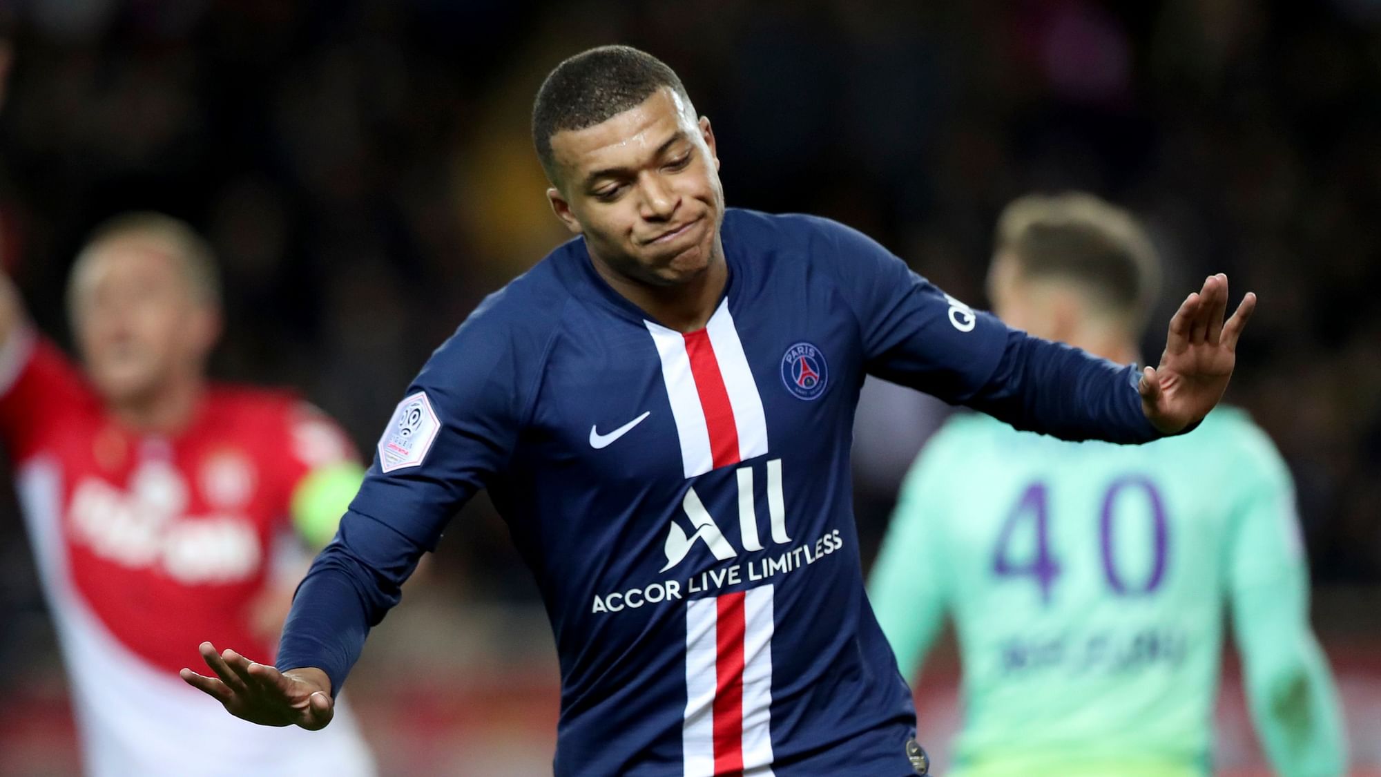 PSG’s Kylian Mbappe celebrates after scoring his side’s opening goal during the French League One soccer match between Monaco and Paris Saint-Germain.