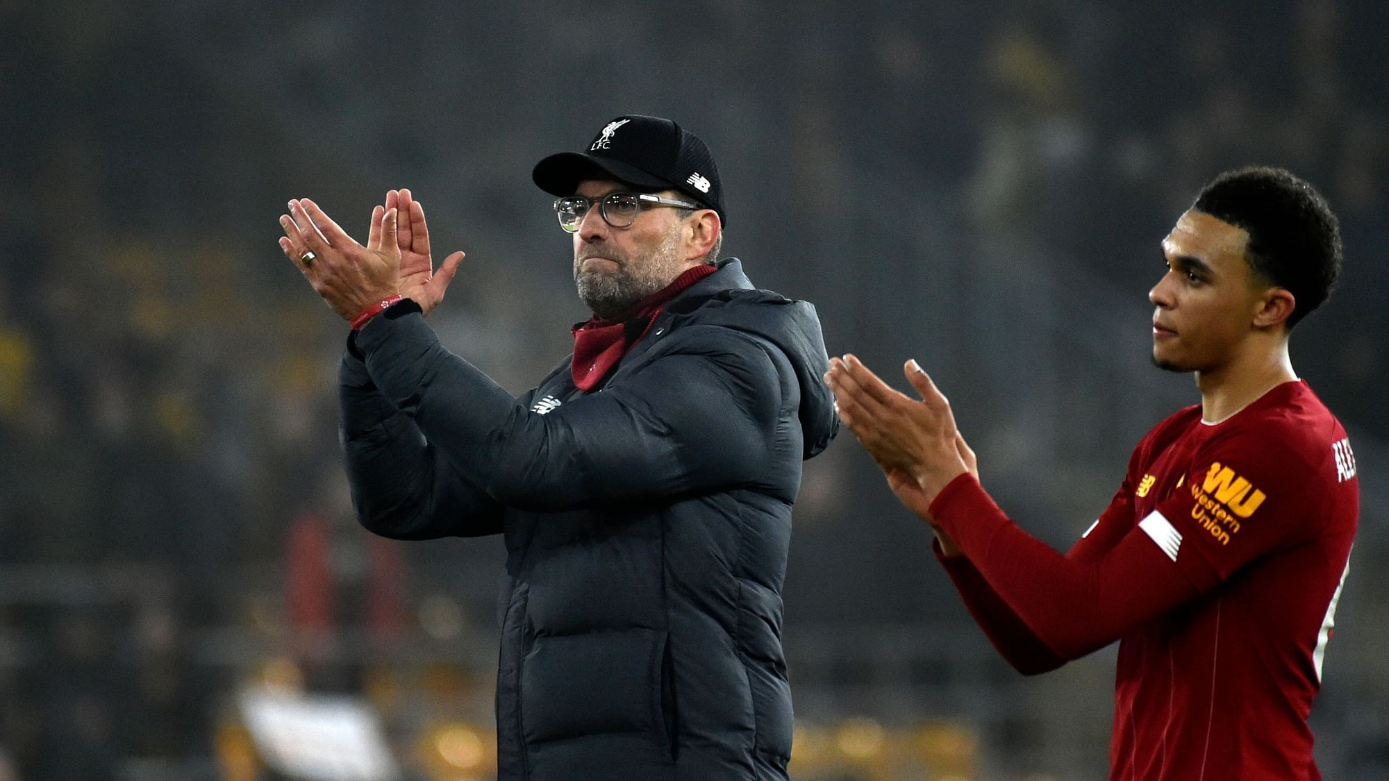 Liverpool’s manager Jurgen Klopp, left, and Liverpool’s Trent Alexander-Arnold greet supporters at the end of the English Premier League soccer match between Wolverhampton Wanderers and Liverpool.