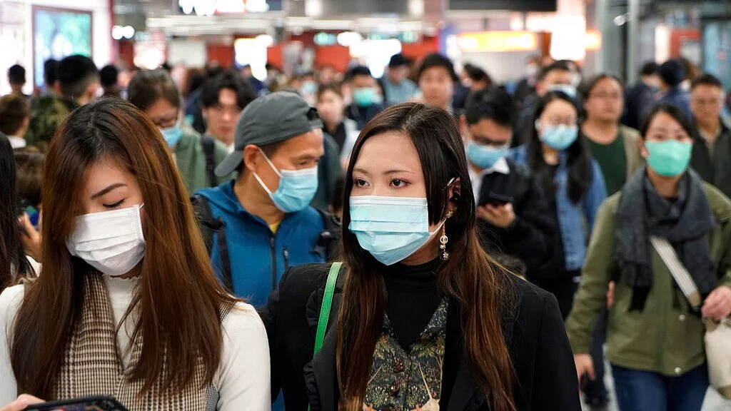 Passengers wear masks to prevent an outbreak of a new coronavirus in a subway station, in Hong Kong.