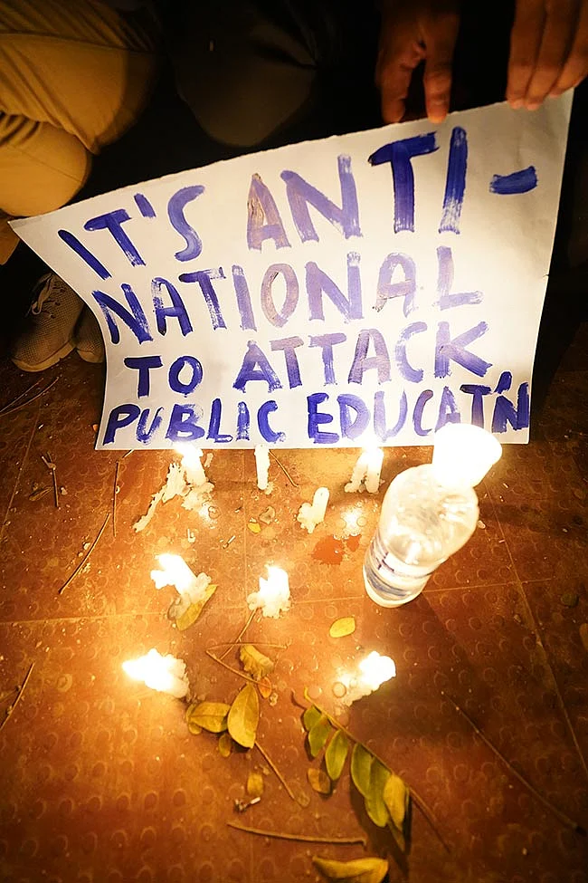 Protesters holding posters condemning the violence at JNU.