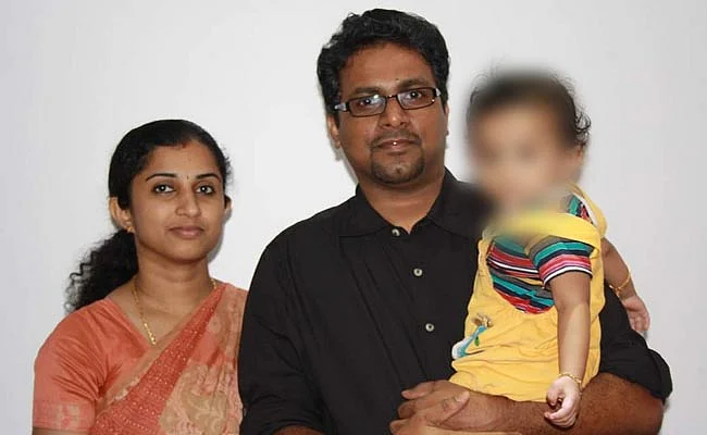39-year-old Renjith Kumar TB with his wife, 34-year-old Indu Renjith, and their child.
