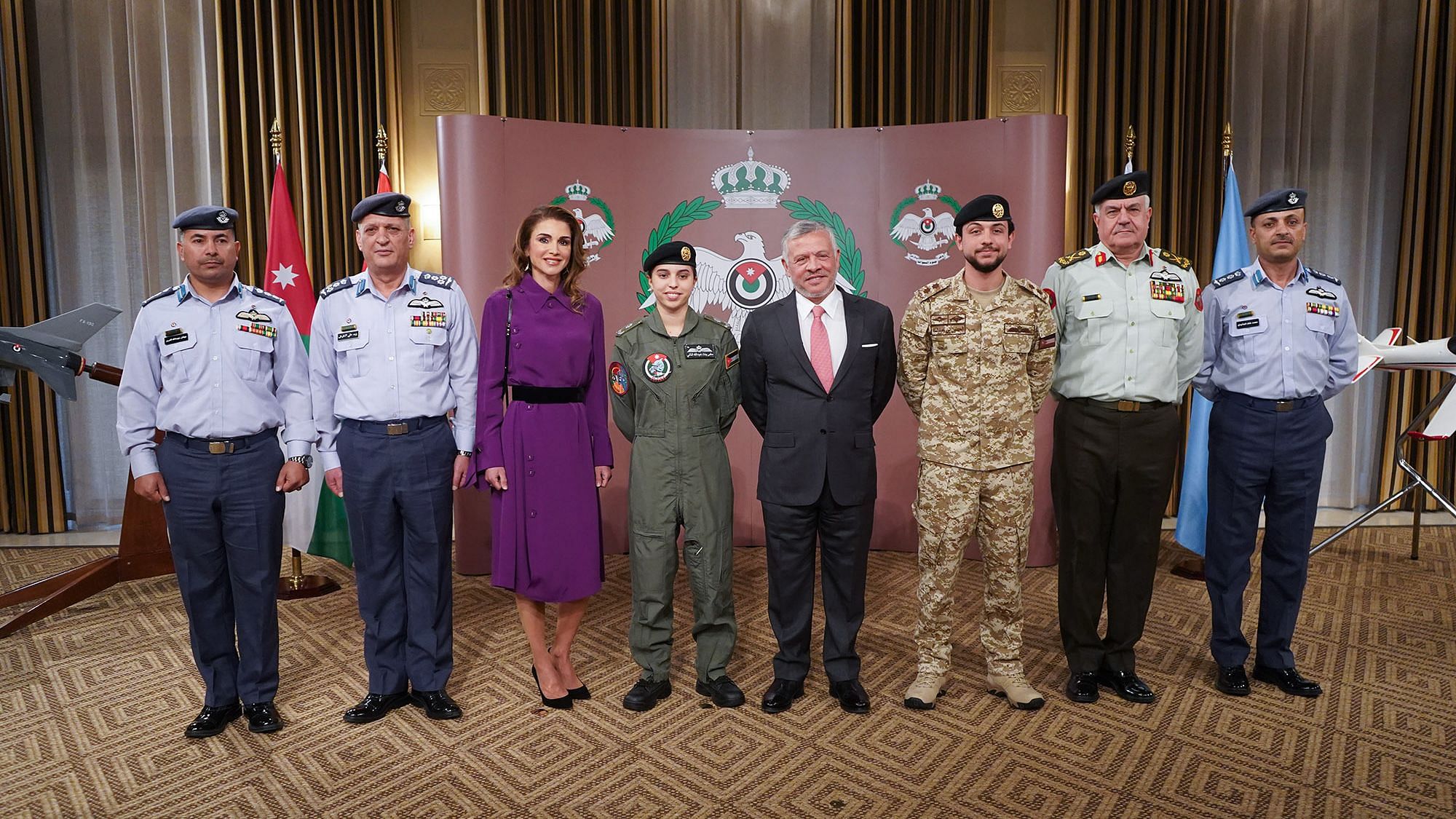 His Majesty King Abdullah II presents Princess Salma  with her wings at a ceremony.