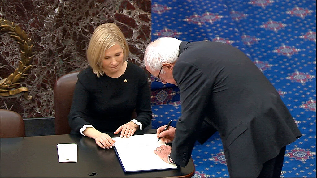 Senator Bernie Sanders signs the oath book after being sworn in for the impeachment trial of President Donald Trump in the Senate at the US Capitol in Washington, Thursday, 16 January 2020.